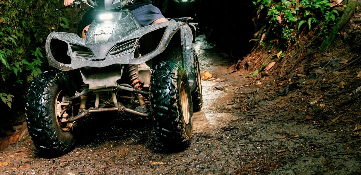 Off road adventure with ATV on narrow muddy adventure